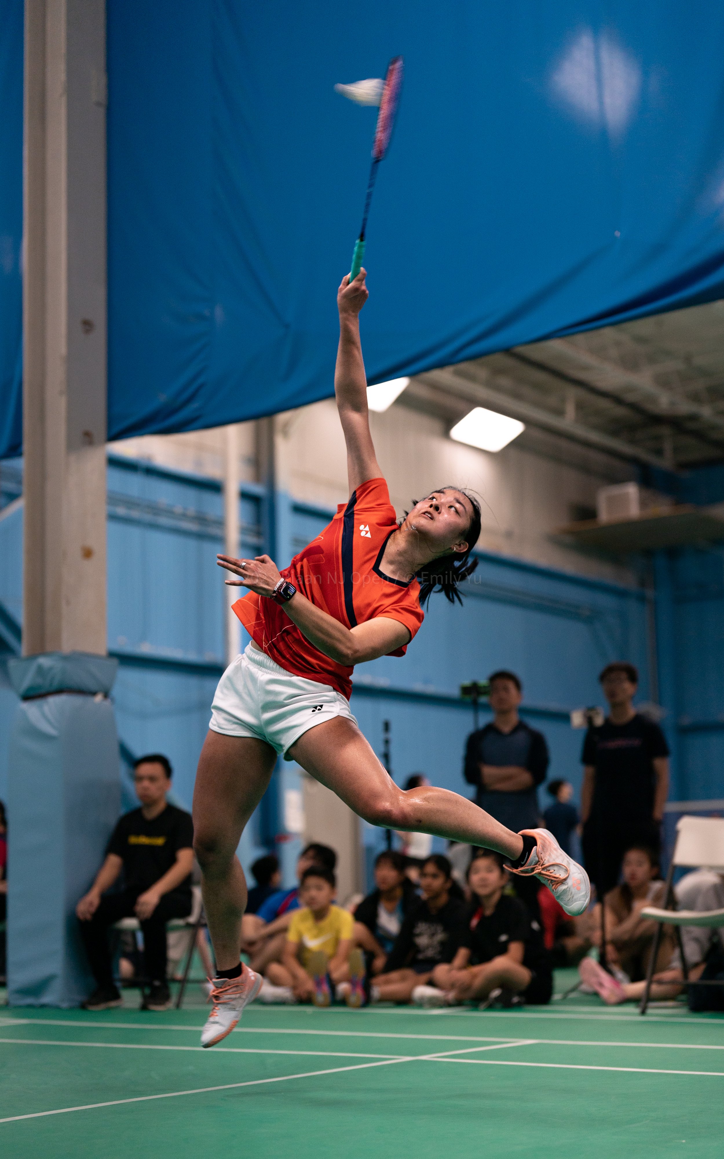 Badminton player mid-air smash